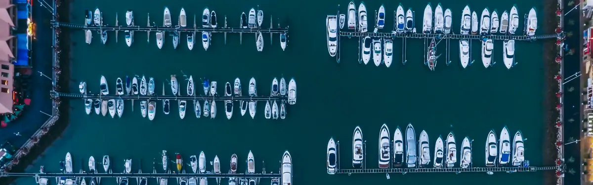white boats on body of water at daytime