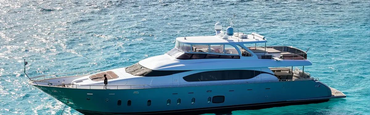 A luxurious yacht is floating on blue water.